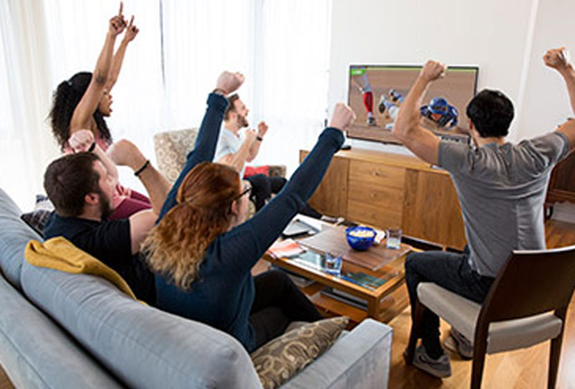 Friends cheering for a baseball game on AirTV